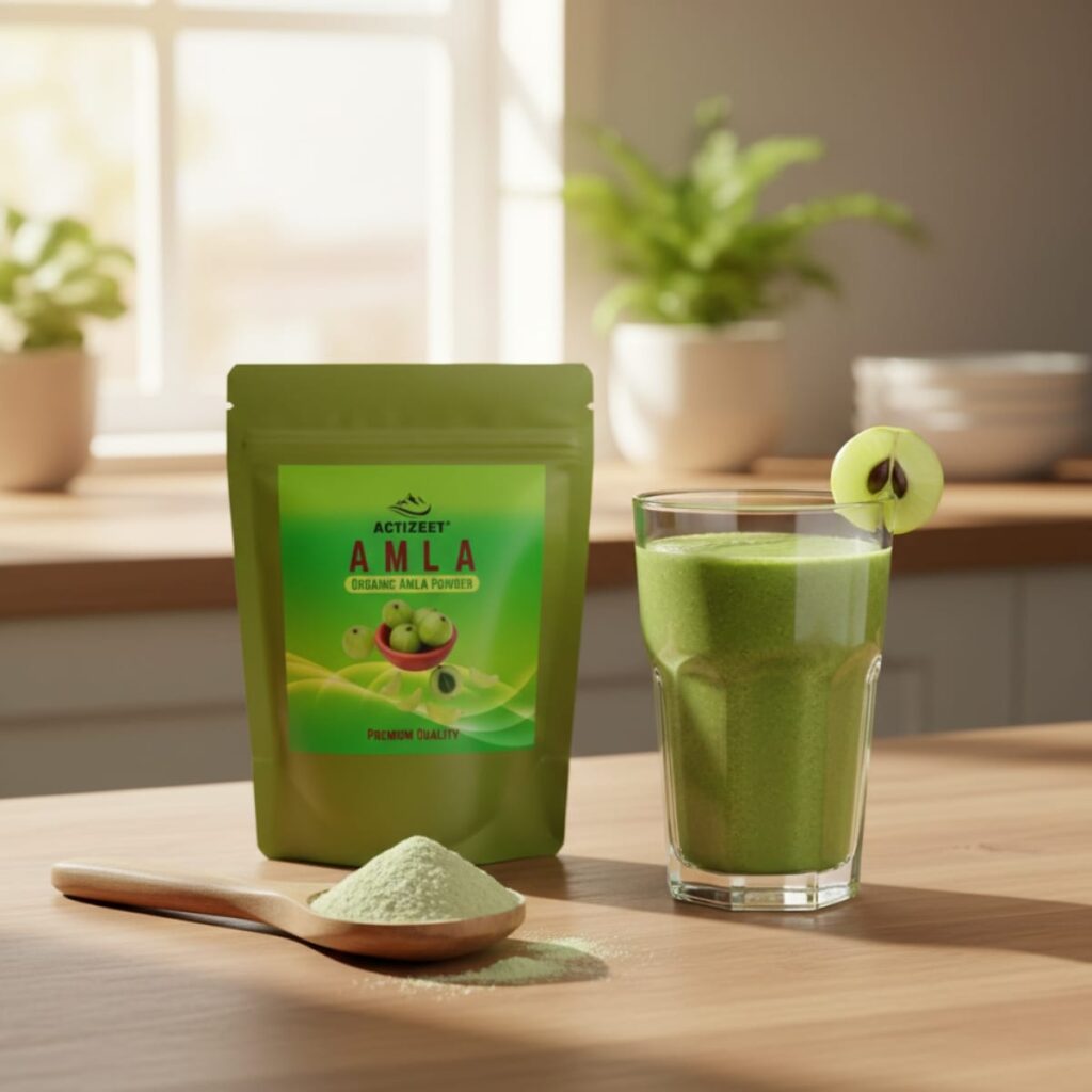 A tall green smoothie glass next to ACTIZEET Amla Powder in morning sunlight.