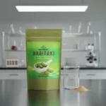 ACTIZEET Haritaki on metal surface with laboratory beaker